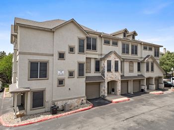 A large two-story building with a garage on the lower level.